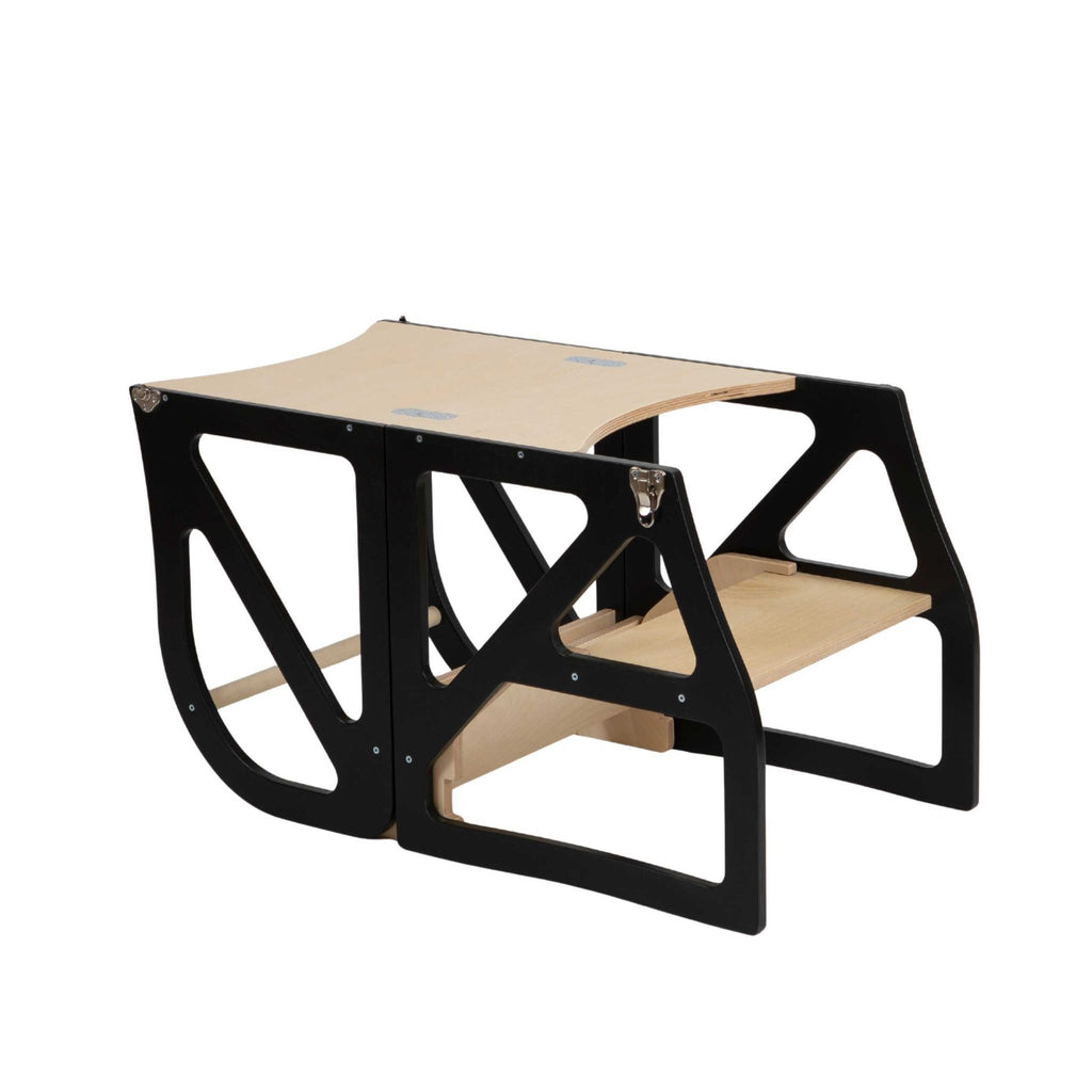 2. Black transformable kitchen tower folded into a toddler table and chair set on a white background