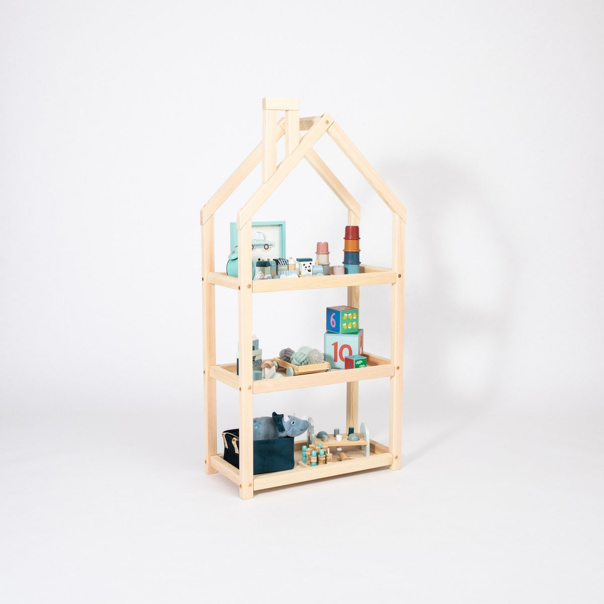3. Studio shot of natural wood house-shaped shelf with toys and books