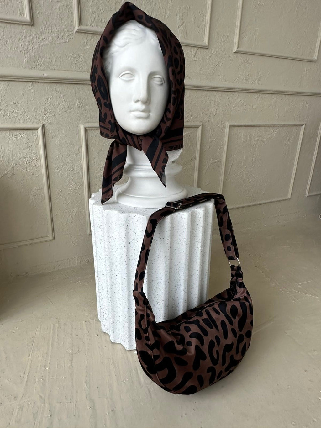 6. Woman with Garbanota Classic Leopard Hobo Bag outdoors, emphasizing bag's versatility and style