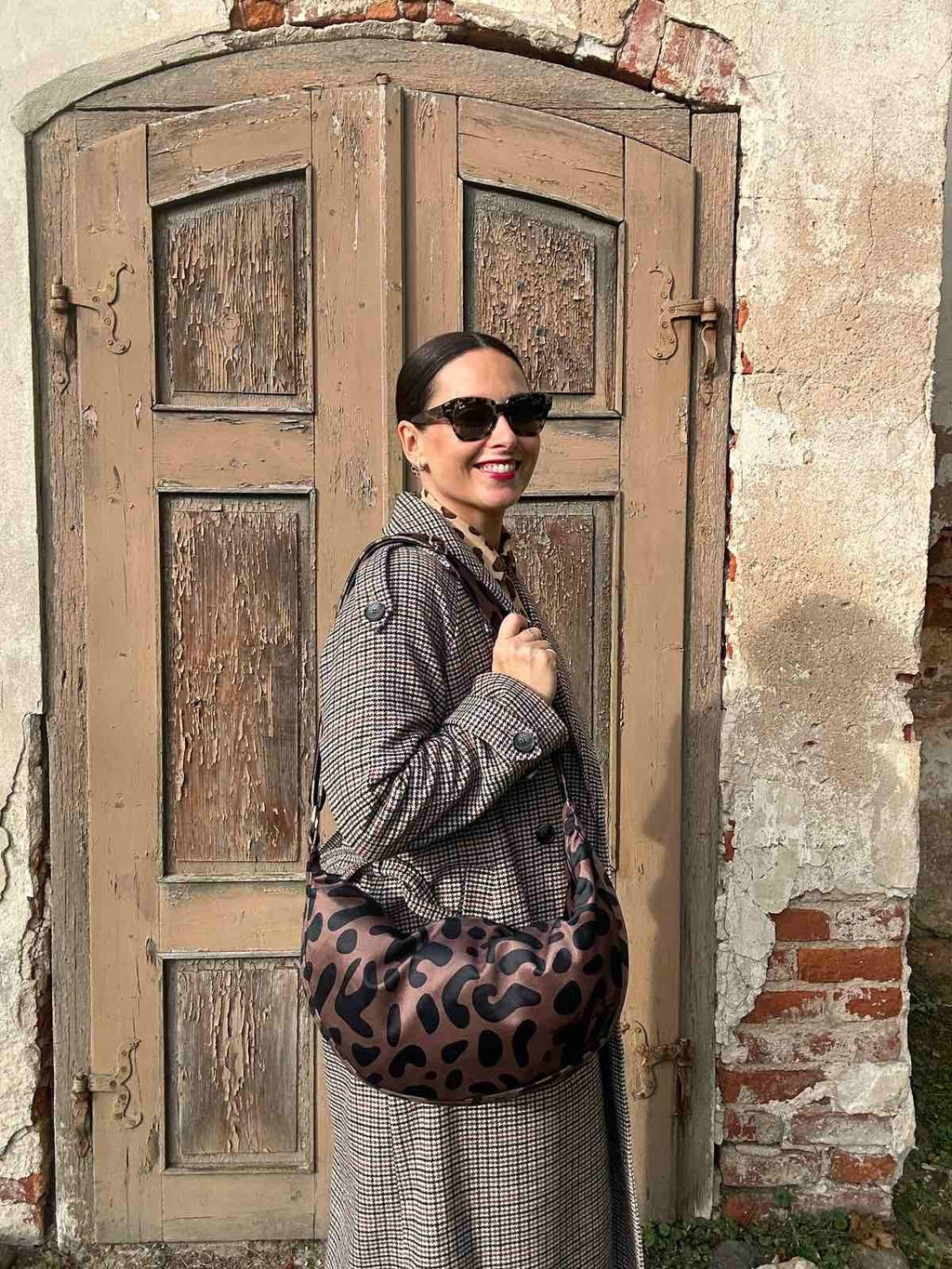 7. Garbanota Classic Leopard Hobo Bag on a bust with scarf, highlighting bag's design and material