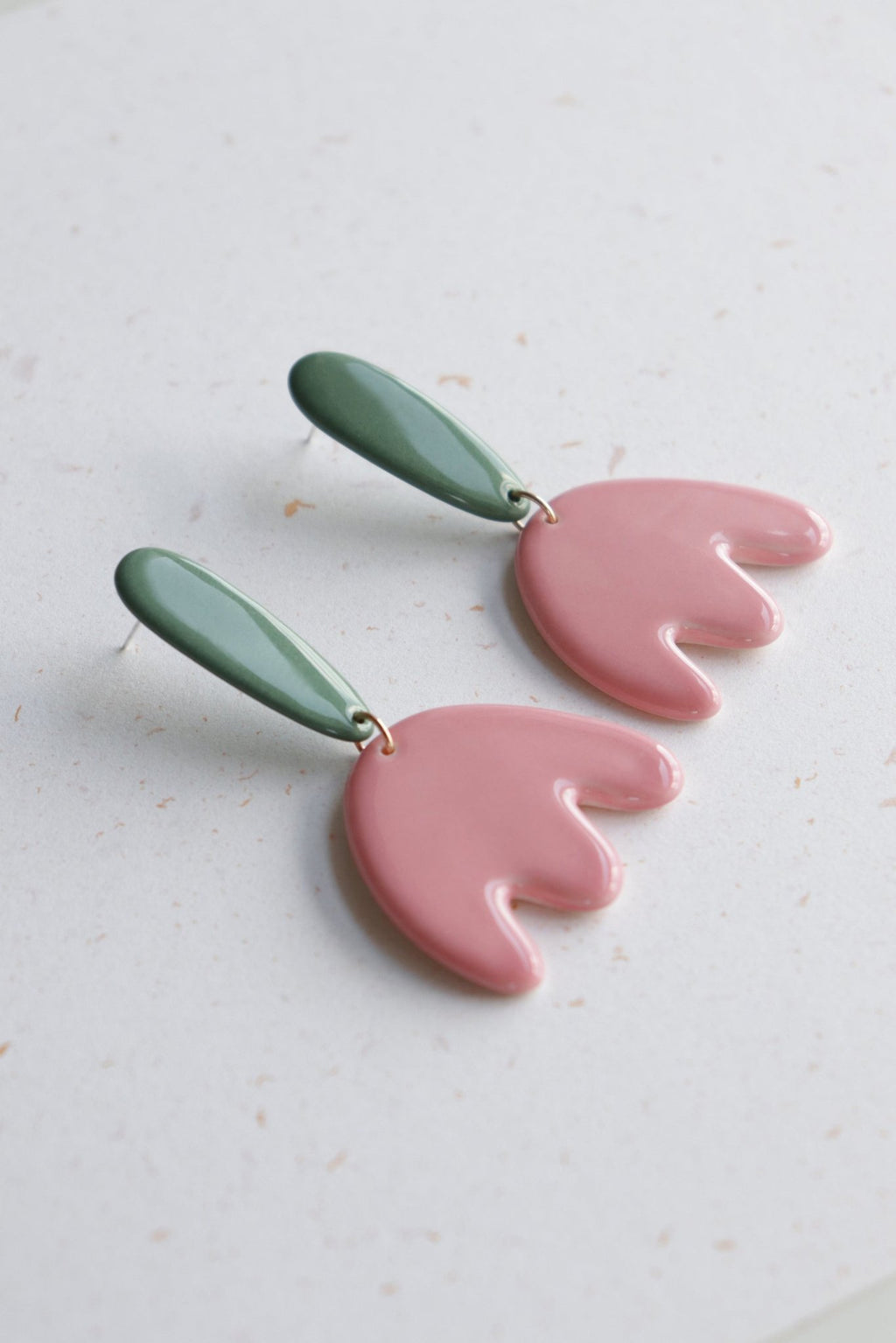 3. Close-up of Rozenthal Porcelain Tulip Earrings featuring pink tulip design with green accents, displayed on a light surface