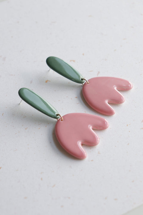 3. Close-up of Rozenthal Porcelain Tulip Earrings featuring pink tulip design with green accents, displayed on a light surface