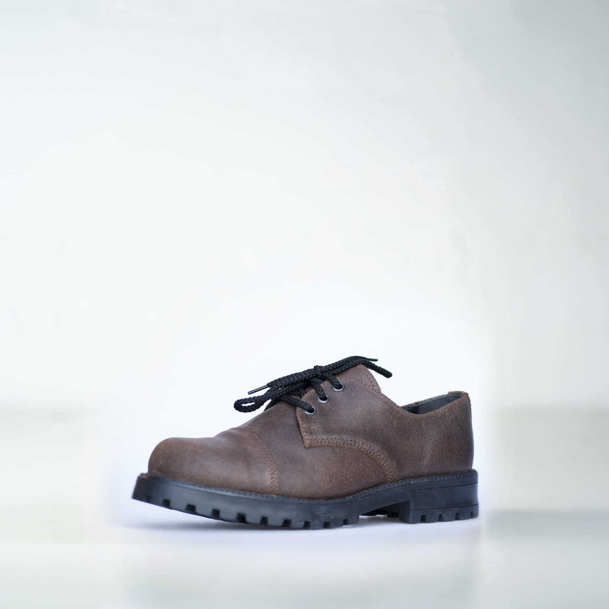 1. Unisex dark brown leather Samelin Widgets shoe with black laces, shown in studio setting