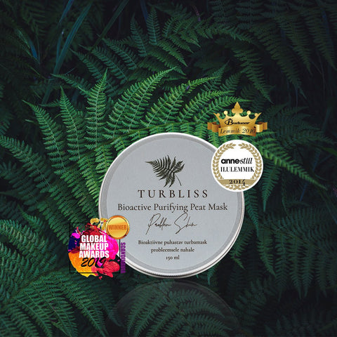 2. Turbliss Bioactive Purifying Peat Mask 150ml with award badges, displayed on lush green ferns