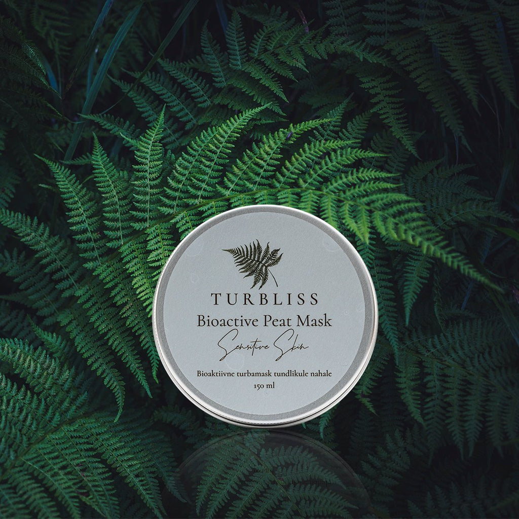 2. Turbliss Bioactive Peat Mask for Sensitive Skin 150ml tin displayed on lush green ferns, emphasizing natural ingredients