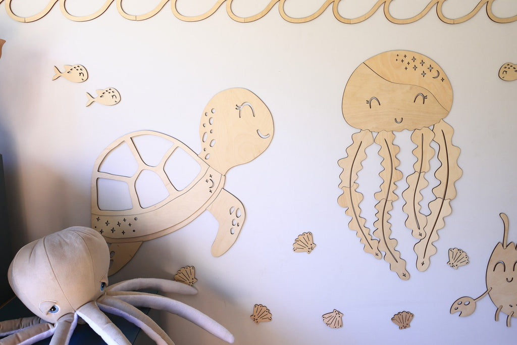 2. Wooden turtle and jellyfish wall decorations with sea-themed extras on a light wall, part of the Ocean Collection by Cut It Now