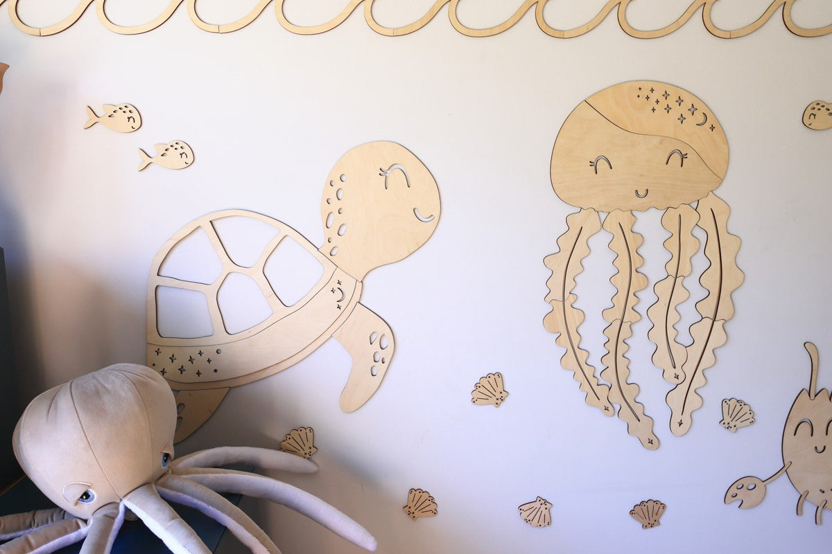 2. Wooden turtle and jellyfish wall decorations with sea-themed extras on a light wall, part of the Ocean Collection by Cut It Now