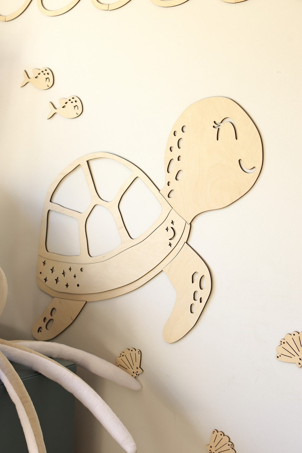 5. Close-up of wooden turtle wall decoration with fish and shell extras on a light wall, part of the Ocean Collection by Cut It Now