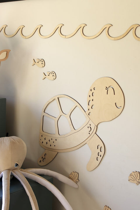 1. Wooden turtle wall decoration with sea-themed extras like fish and shells on a light wall, part of the Ocean Collection by Cut It Now