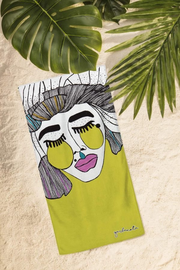 3. Flat lay of Garbanota Towel Veronika in yellow on sand, highlighting unique hand-drawn design