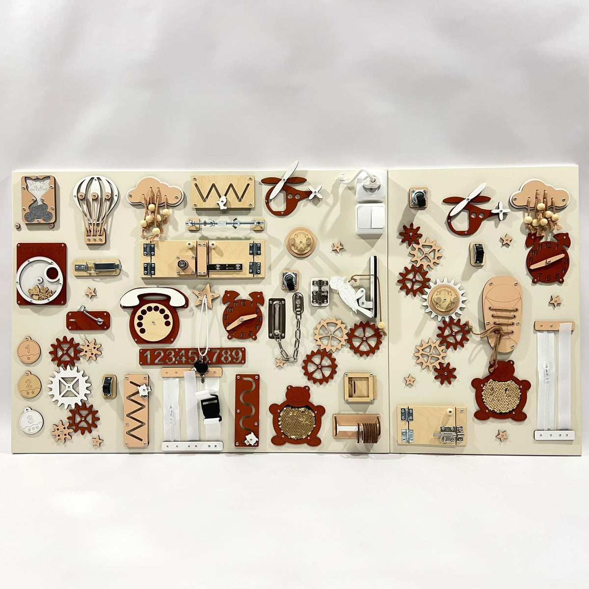 9. Two-piece wall activity panel in red and beige with various interactive elements for children's play, mounted on a white background.