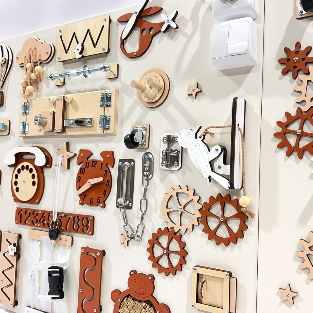 4. Close-up of red and beige wall activity panel showing detailed interactive elements like gears and locks for children's play.