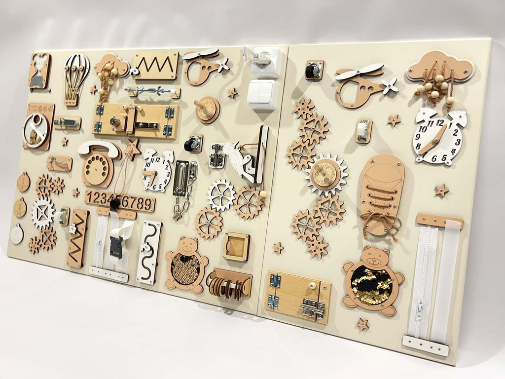 7. Two-piece wall activity panel in beige and white featuring interactive gears, locks, and numbers for children's play, mounted on a white background.