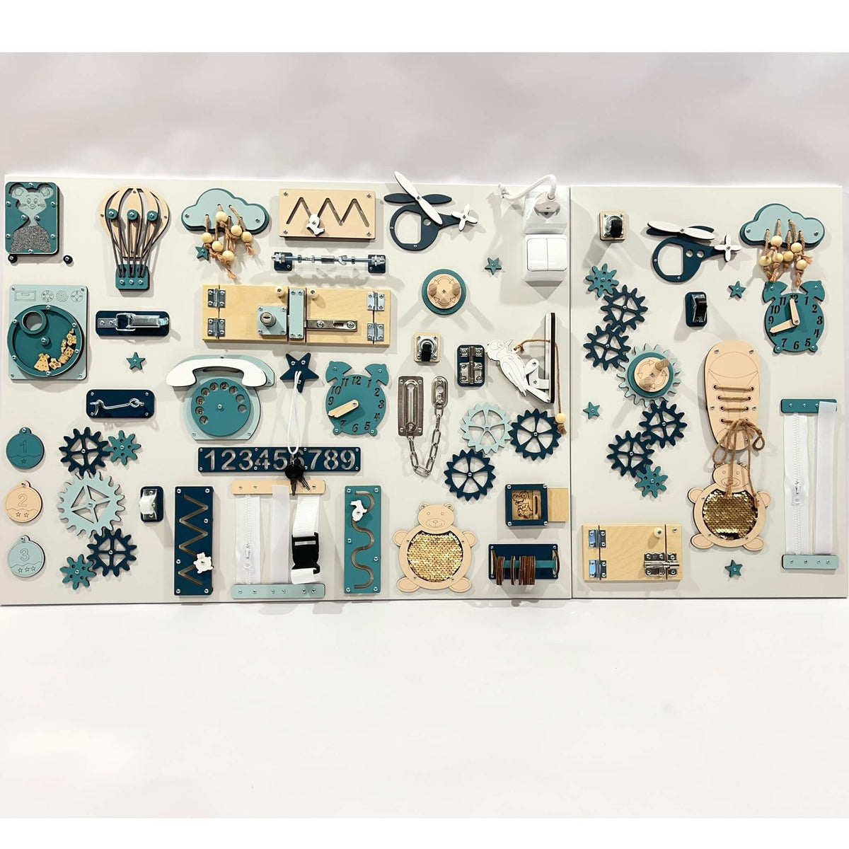 1. Two-piece wall activity panel in blue and beige with various interactive elements for children's play, mounted on a white background.