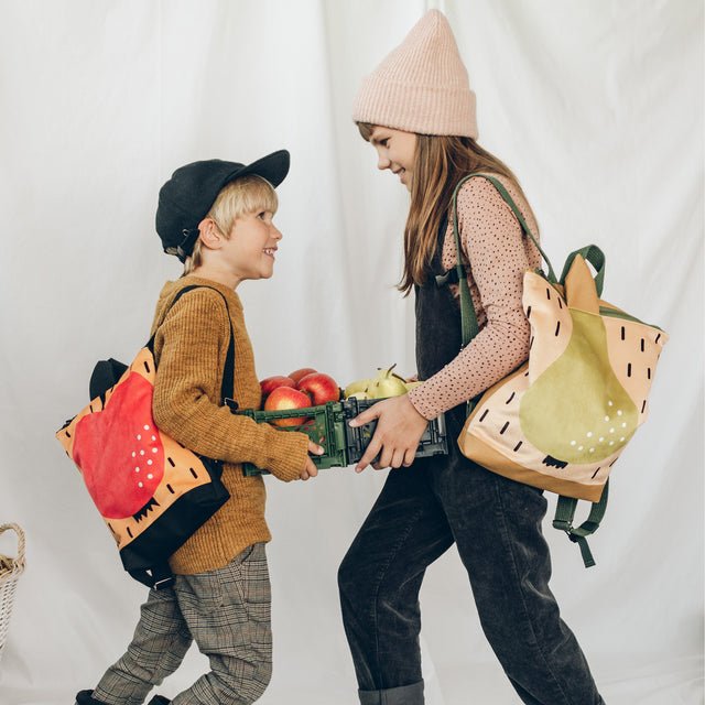 1. Kids wearing Muni PEAR backpacks, girl with pear design, boy with apple design, lifestyle setting