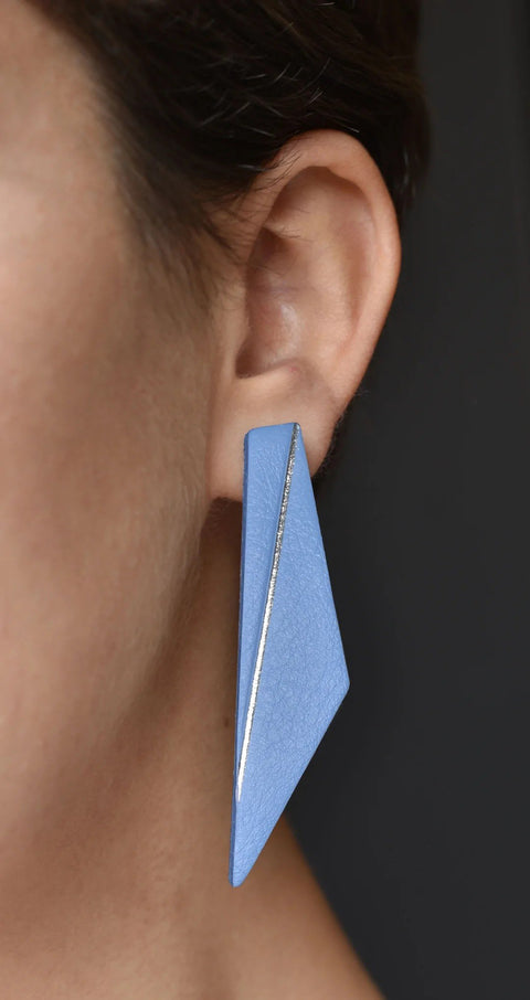 1. Women's Lühikesed Wing earring in light blue by Gerda Retter Design, shown worn on ear, highlighting geometric shape and silver backing