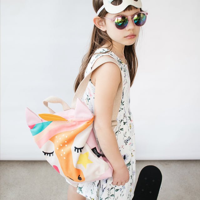7. Close-up of girl wearing MUNI Unicorn backpack, showcasing unicorn design and comfortable fit