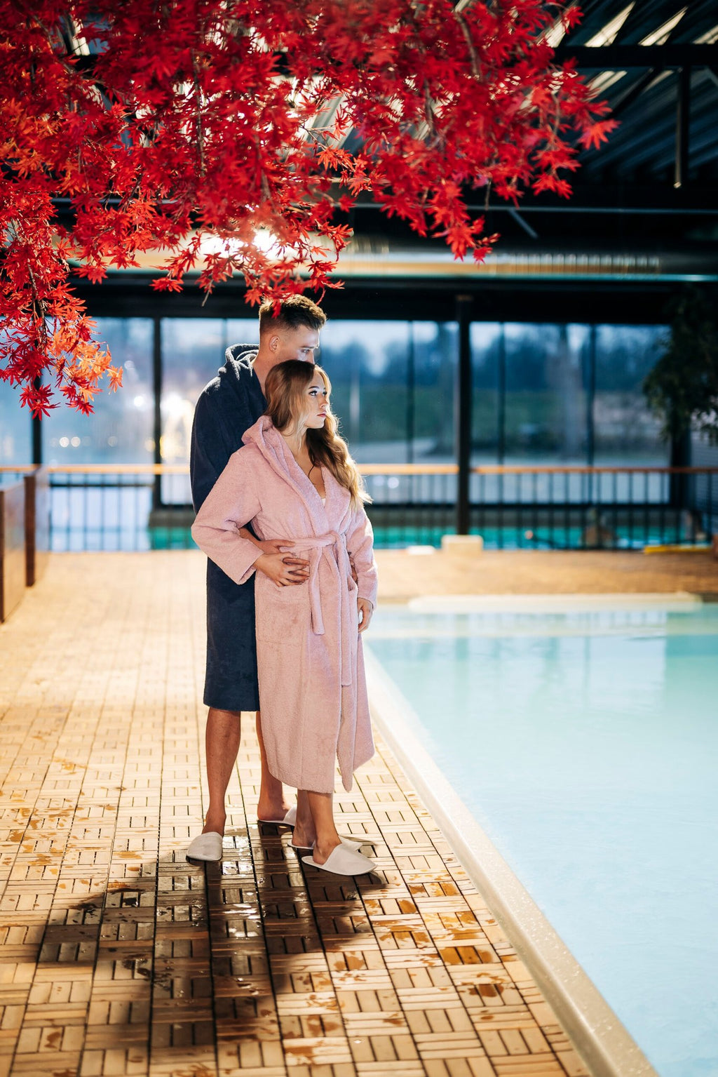 2. Unisex cotton terry bathrobes by RÄTT worn by couple near pool