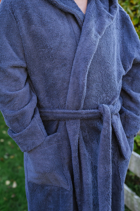 4. Close-up of blue RÄTT unisex bathrobe highlighting texture and belt
