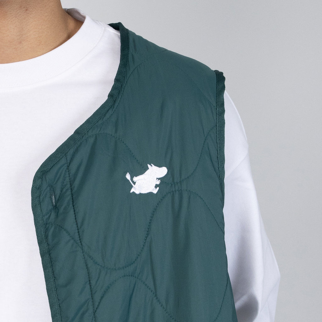 3. Close-up of Moomin logo on green quilted vest fabric