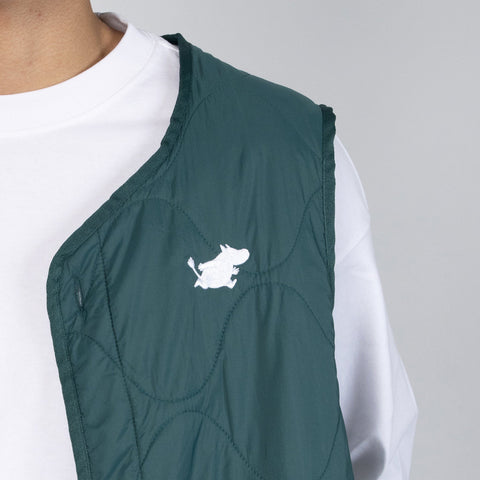 3. Close-up of Moomin logo on green quilted vest fabric