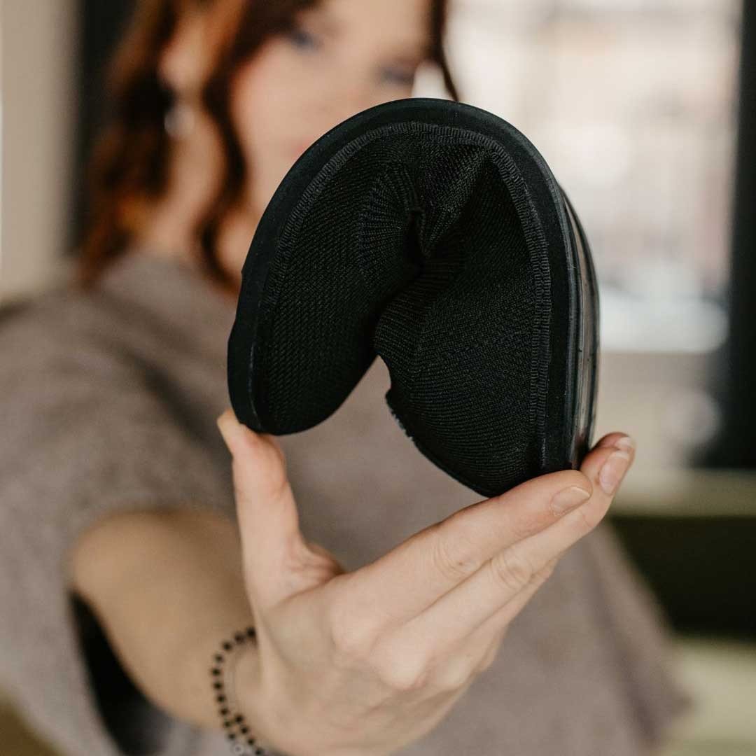 5. Close-up of black upcycled ballerina shoe by Kira Sustainable, highlighting flexible and foldable design