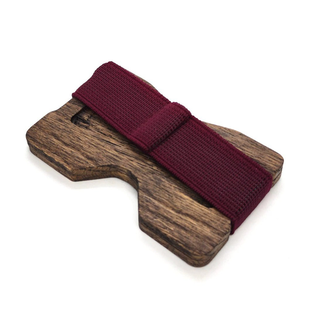 2. Angled view of oak card holder with purple elastic band on white background