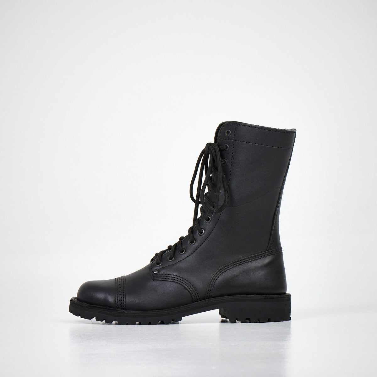 4. Side view of AIPI 2.2 handmade leather boots in black, featuring lace-up design and triple-stitched rubber sole
