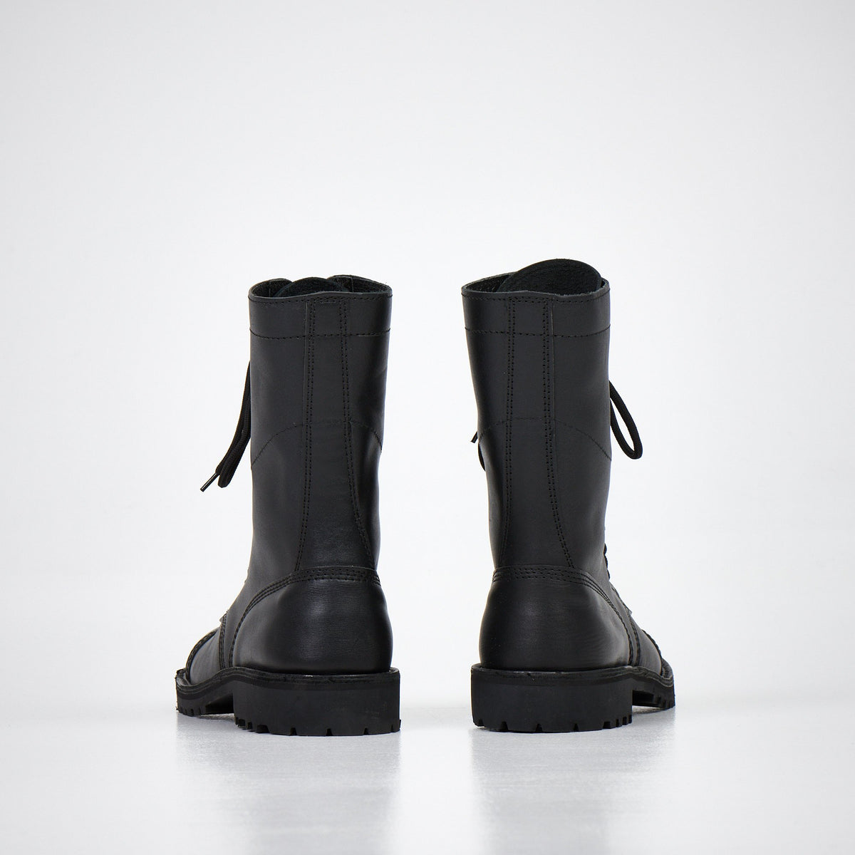 1. AIPI 2.2 handmade leather boots in black, side view showcasing triple-stitched rubber sole and lace-up design