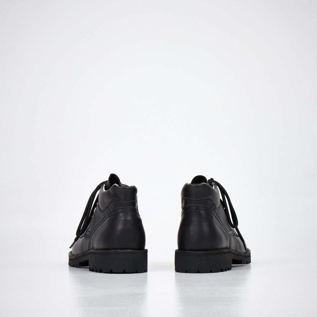 1. Studio shot of AIPI Handmade Ankle Boots in black leather, side view showing laces and stitched rubber soles