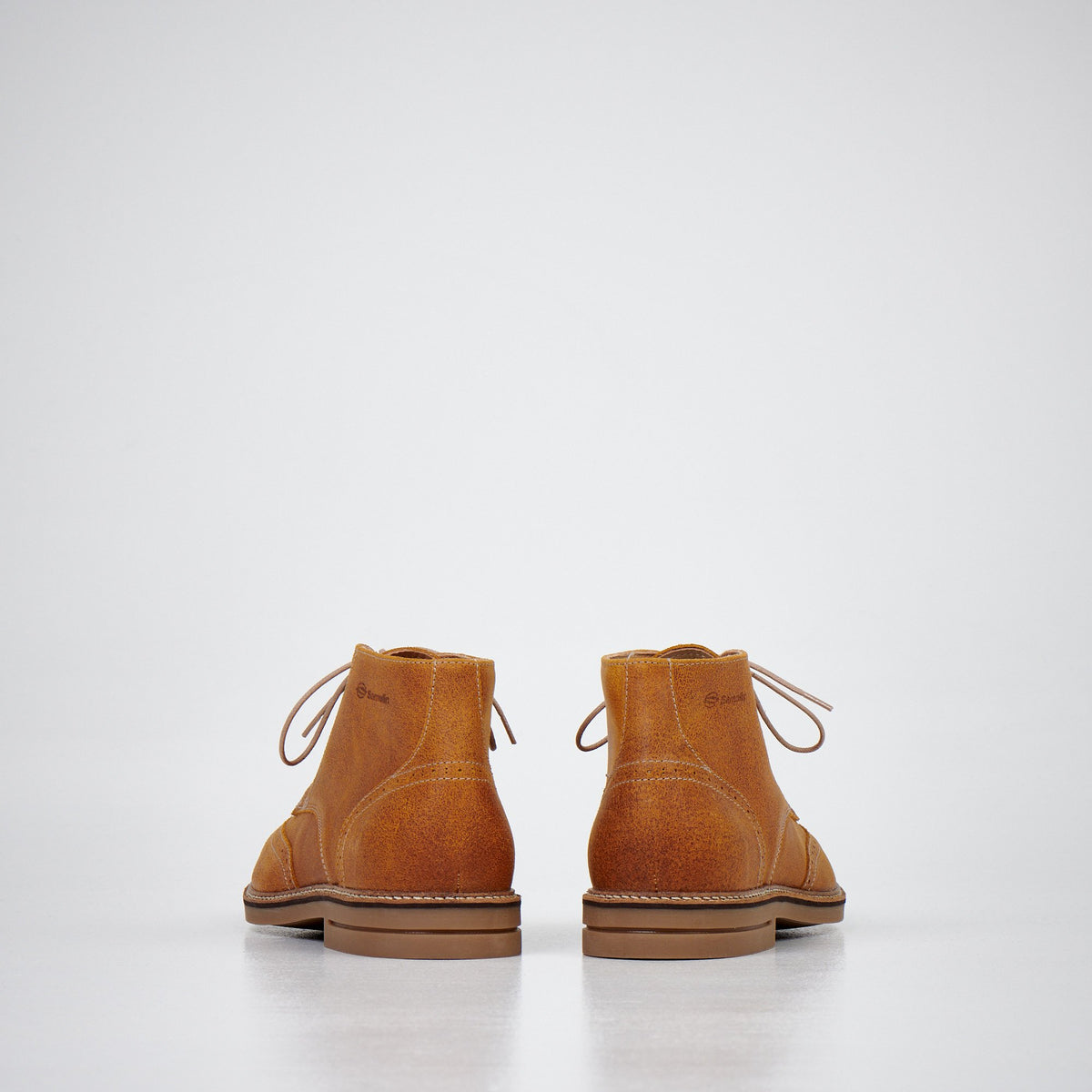 4. Men's light brown ankle boots by Samelin in studio, back view displaying heel and stitching details