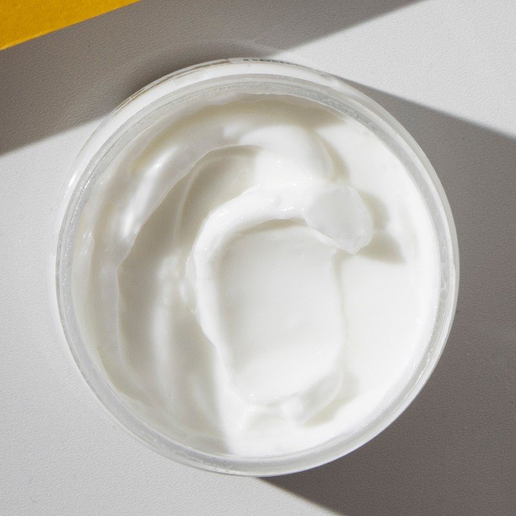 4. Close-up of Vegan Fox Lavender Body Cream texture in open jar, emphasizing smooth consistency