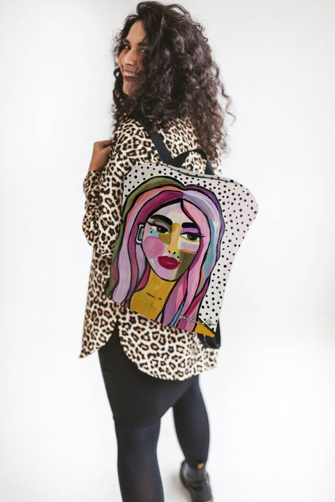 1. Woman wearing Garbanota BACKPACK JURATE with Dovilė Aleksonė artwork, shown in lifestyle setting