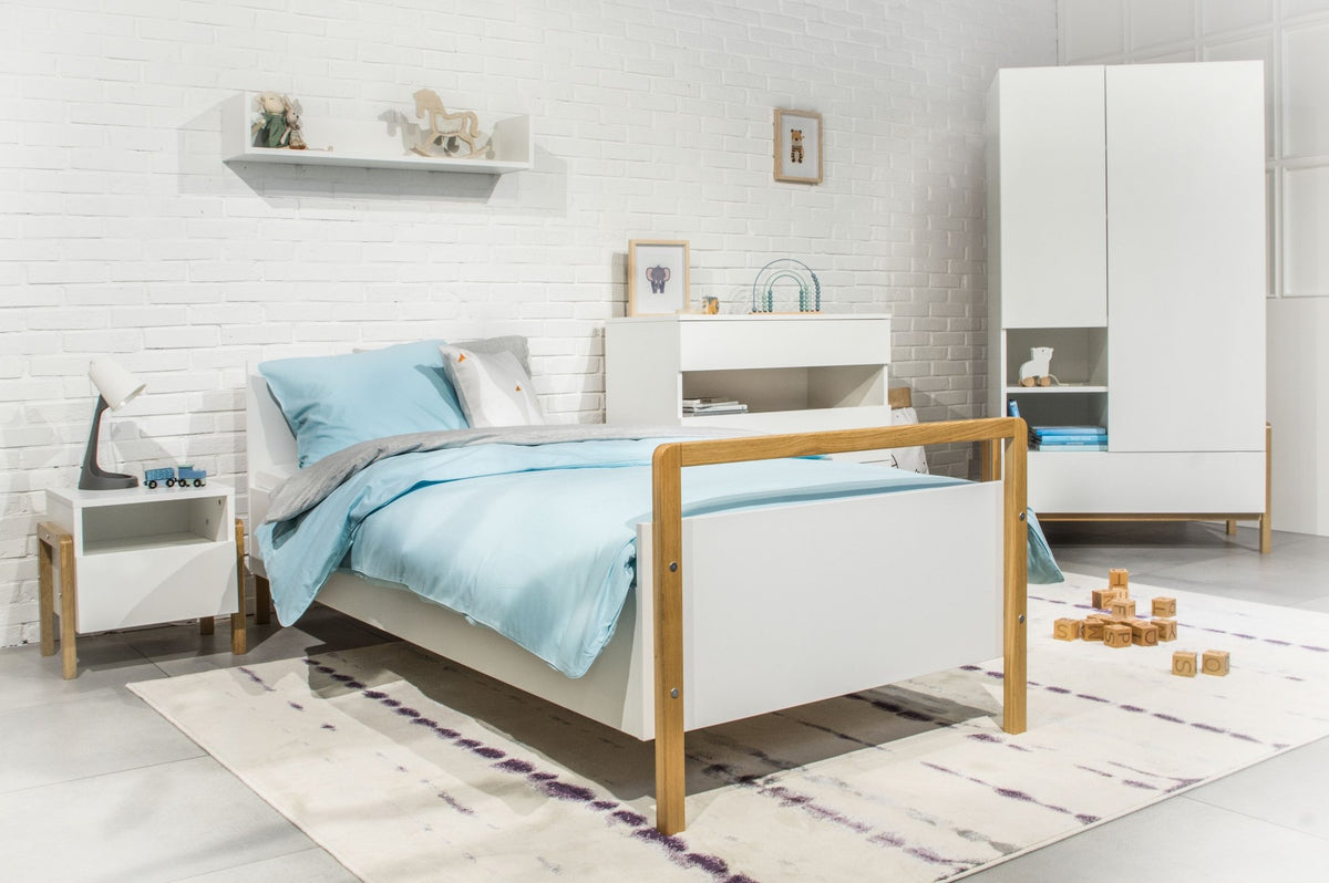 1. Victor children's bed in a modern room with blue bedding, white furniture, and decorative items