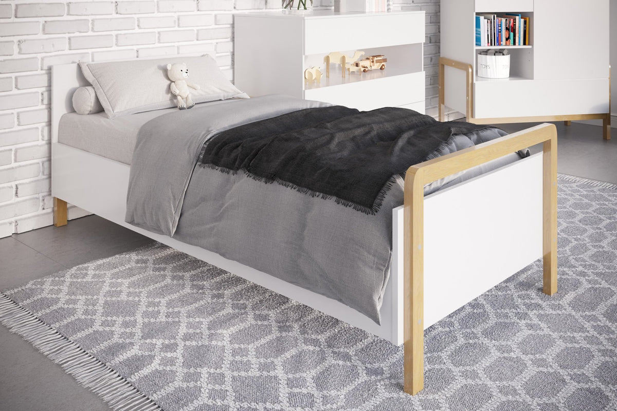 1. Victor children's bed with grey bedding in a stylish room with white furniture and a patterned rug