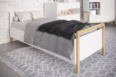 1. Victor children's bed with grey bedding in a stylish room with white furniture and a patterned rug