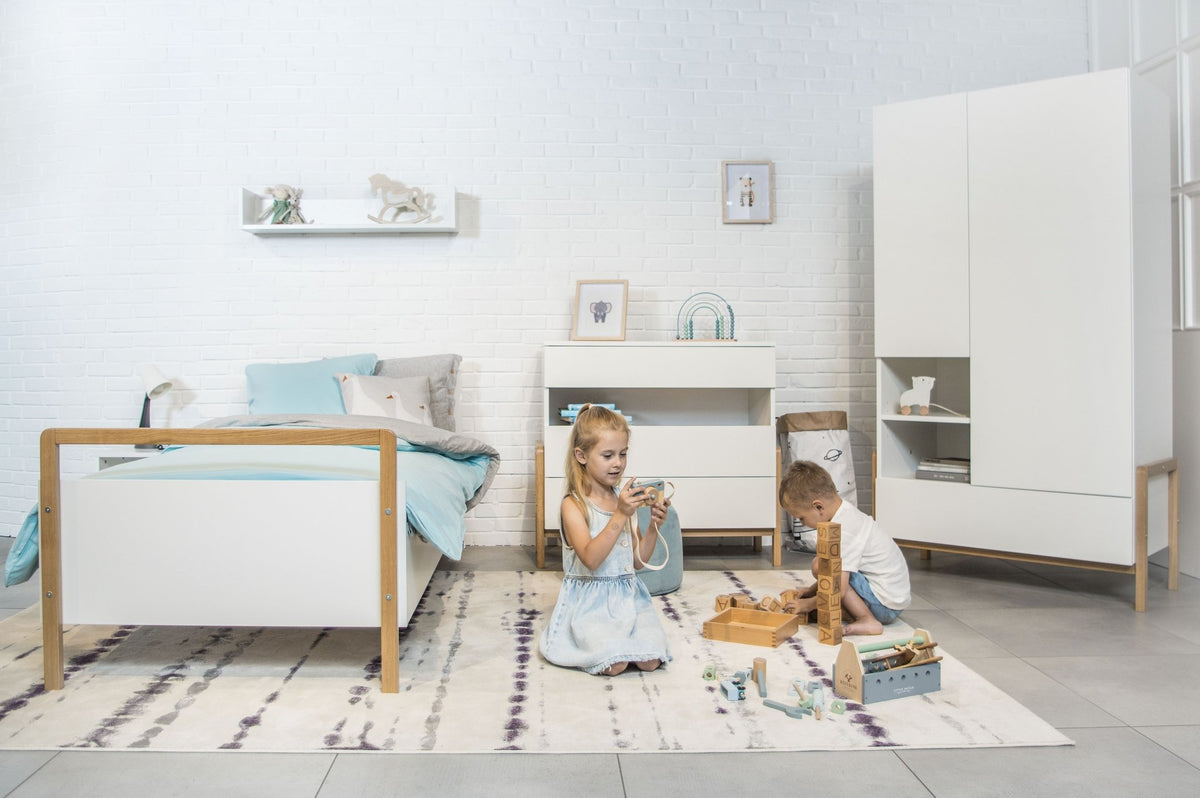 1. Two children playing in a room with Victor children's bed, white furniture, and toys