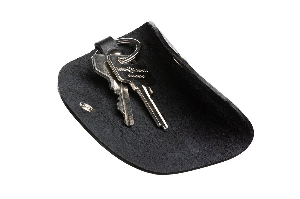 2. Open black leather key holder by Stella Soomlais with keys inside, shown on a white background