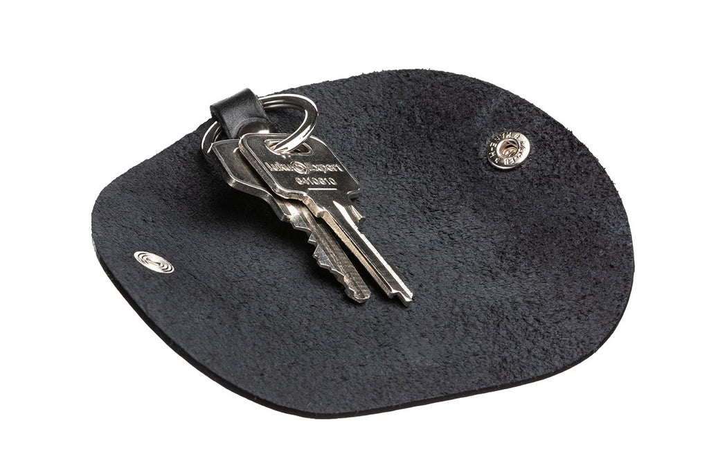 3. Black leather key holder by Stella Soomlais laid flat with keys, highlighting interior texture