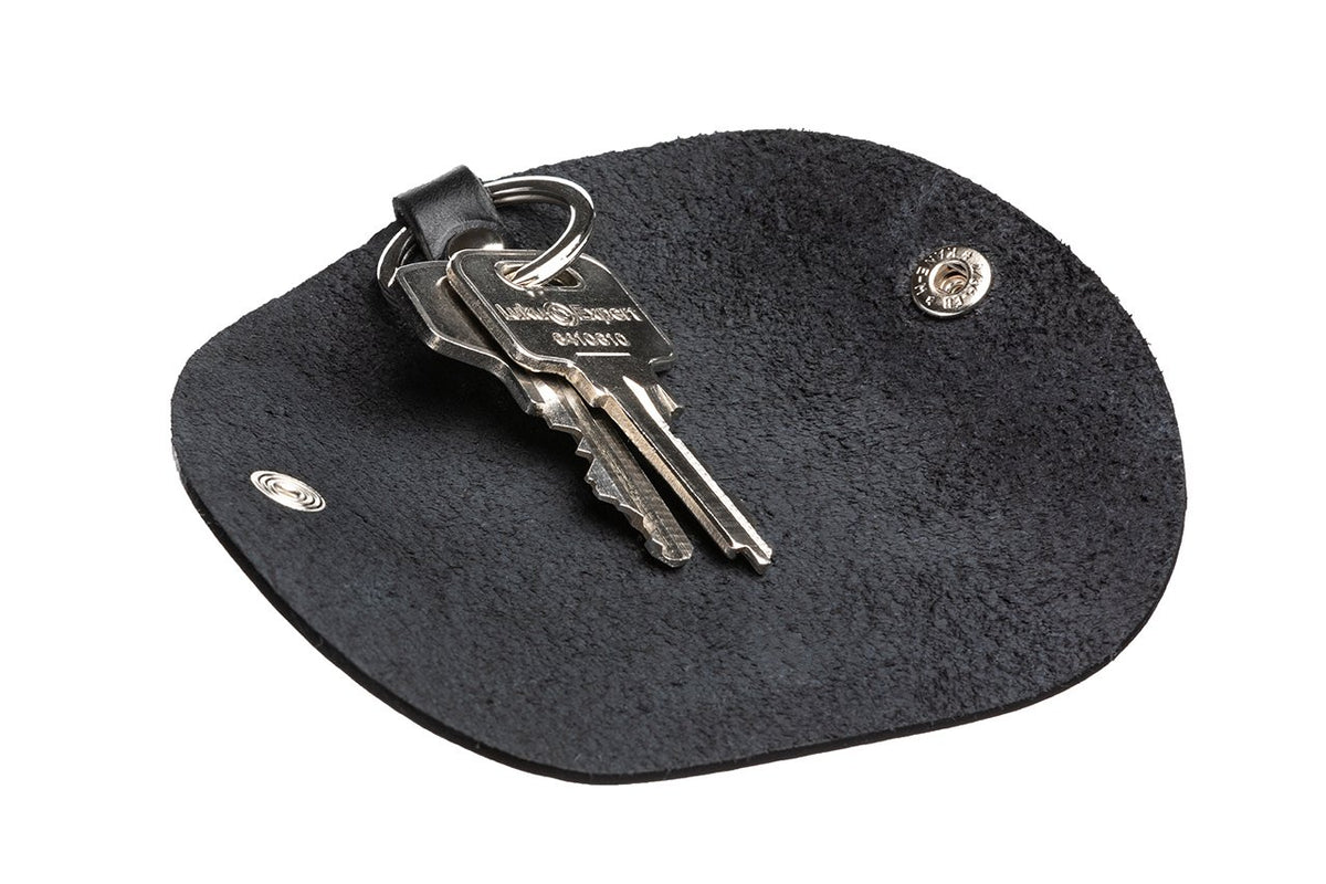 3. Black leather key holder by Stella Soomlais laid flat with keys, highlighting interior texture