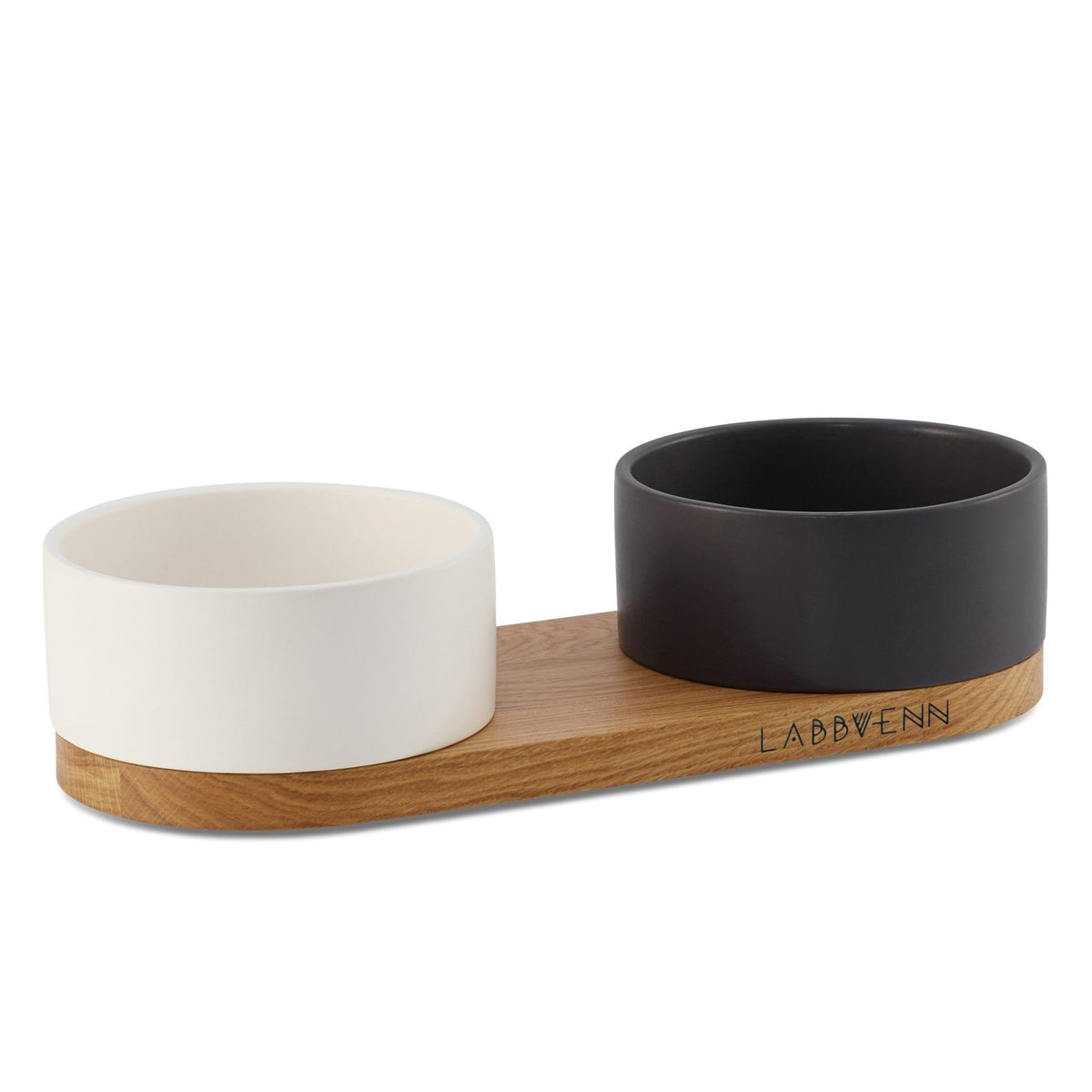 2. Labbvenn Vuku ceramic double buffet with black and white bowls on oak wood base, ideal for pet feeding and watering, shown in studio setting highlighting design and material quality