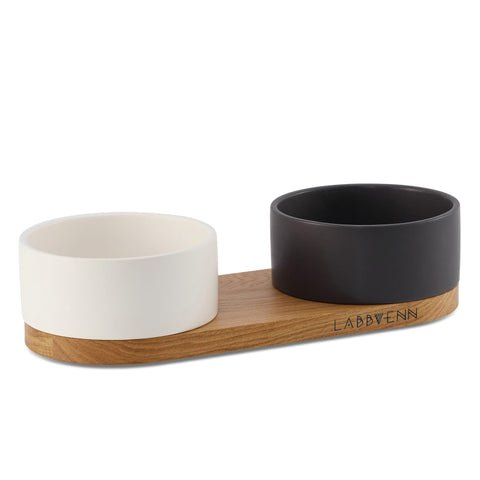 2. Labbvenn Vuku ceramic double buffet with black and white bowls on oak wood base, ideal for pet feeding and watering, shown in studio setting highlighting design and material quality