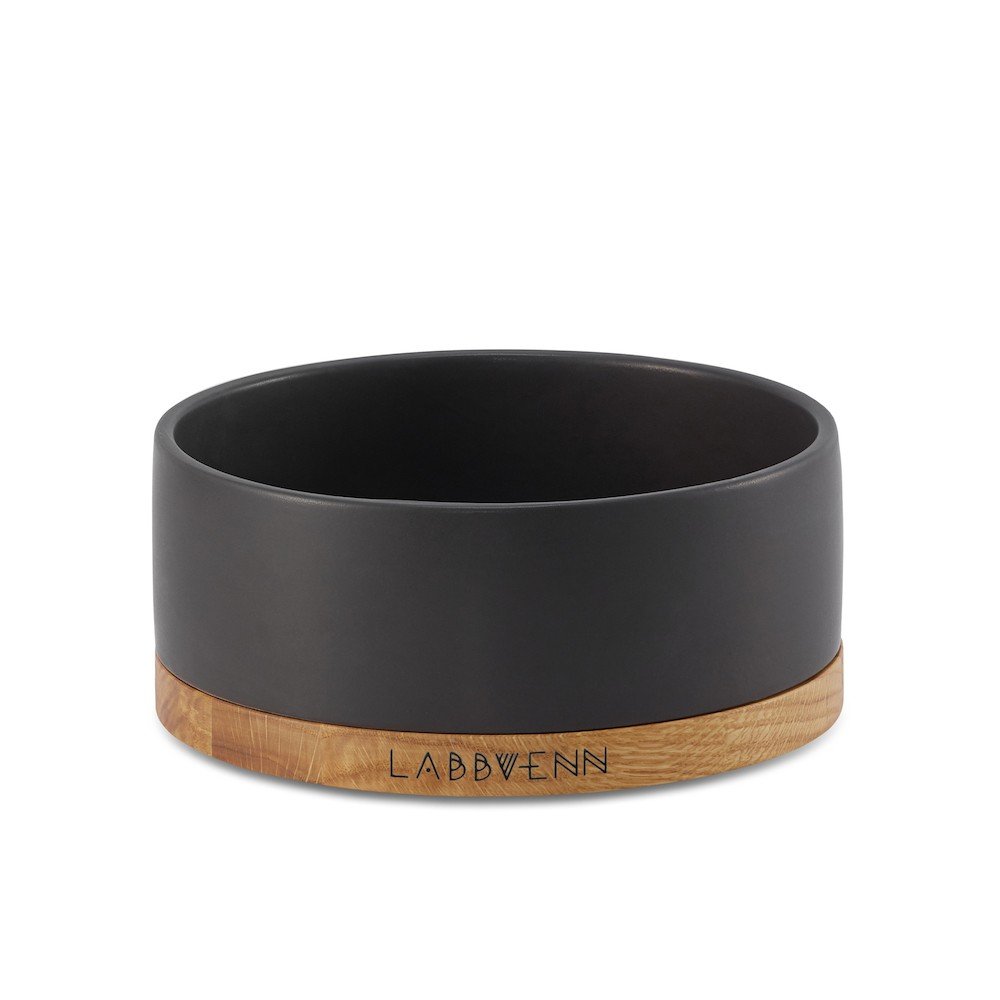 2. Black ceramic pet bowl with oak wood base featuring Labbvenn logo, shown in studio setting highlighting elegant design and material contrast
