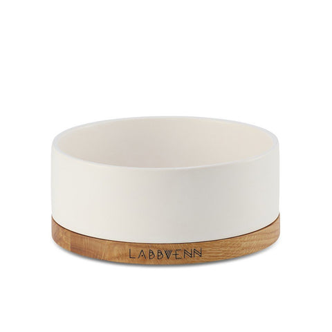 2. White ceramic pet bowl with oak wood base featuring Labbvenn logo, shown in studio setting highlighting elegant design