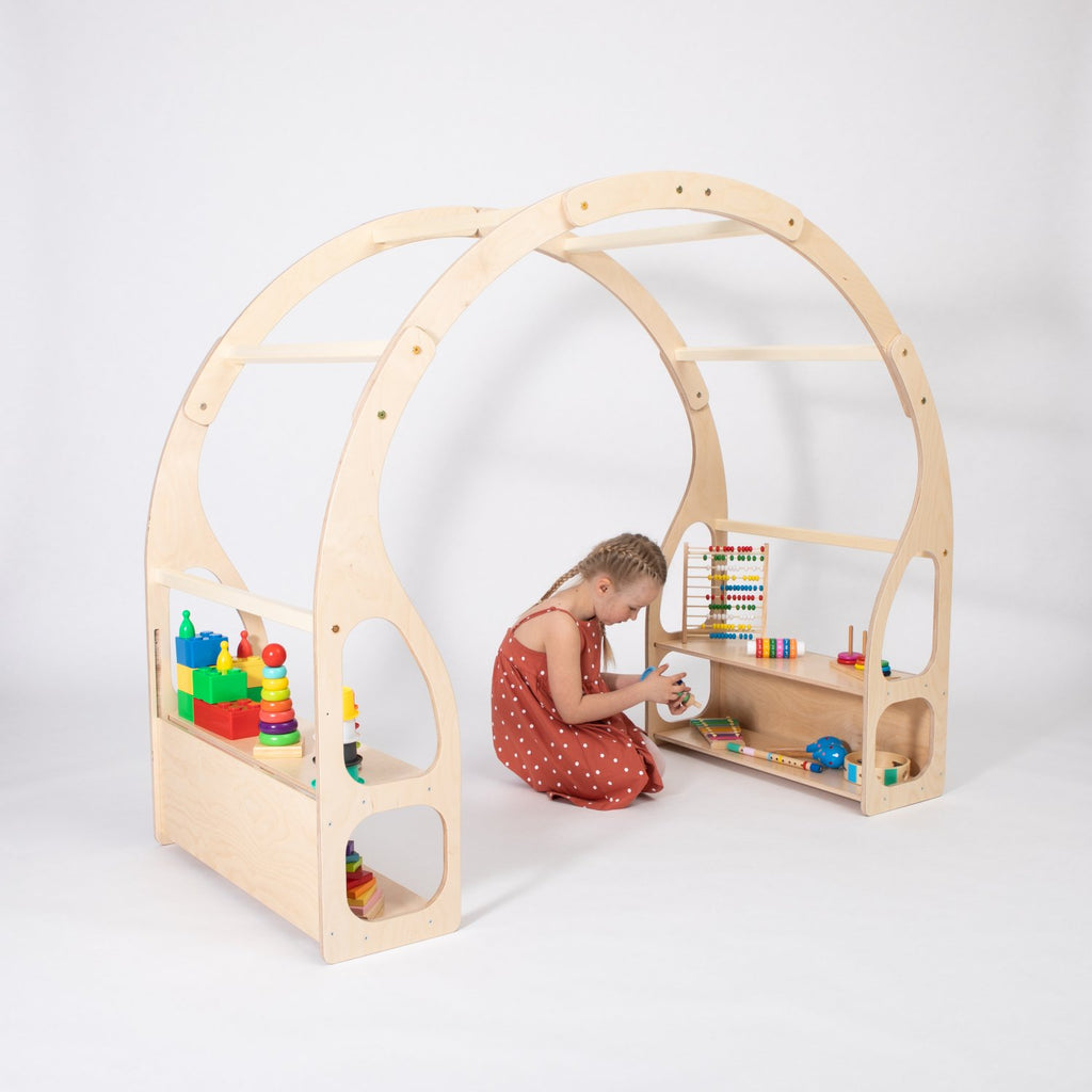 1. Child playing with toys on Montessori play stand made of birch plywood in a white studio setting