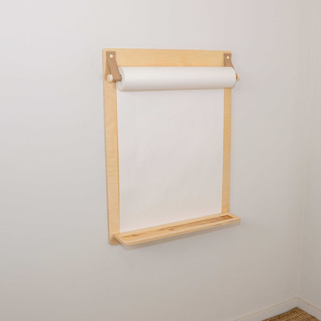 2. Wooden wall-mounted drawing board with paper roll and pencil ledge in studio setting