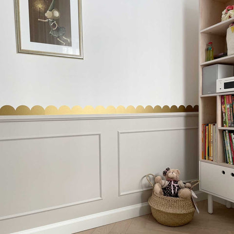 3. Golden circle wall stickers in a room with a basket of toys and a bookshelf
