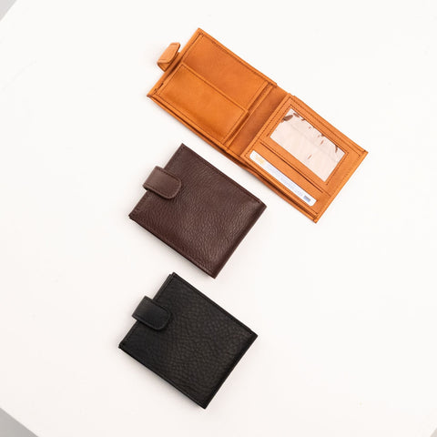 3. Flat lay of men's leather wallets in tan, brown, and black by Papillon, showcasing interior and exterior design