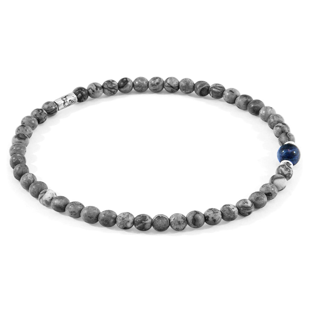 1. ANCHOR & CREW Walter Silver and Stone SKINNY Bracelet with grey jasper and blue sodalite stones, shown in studio setting