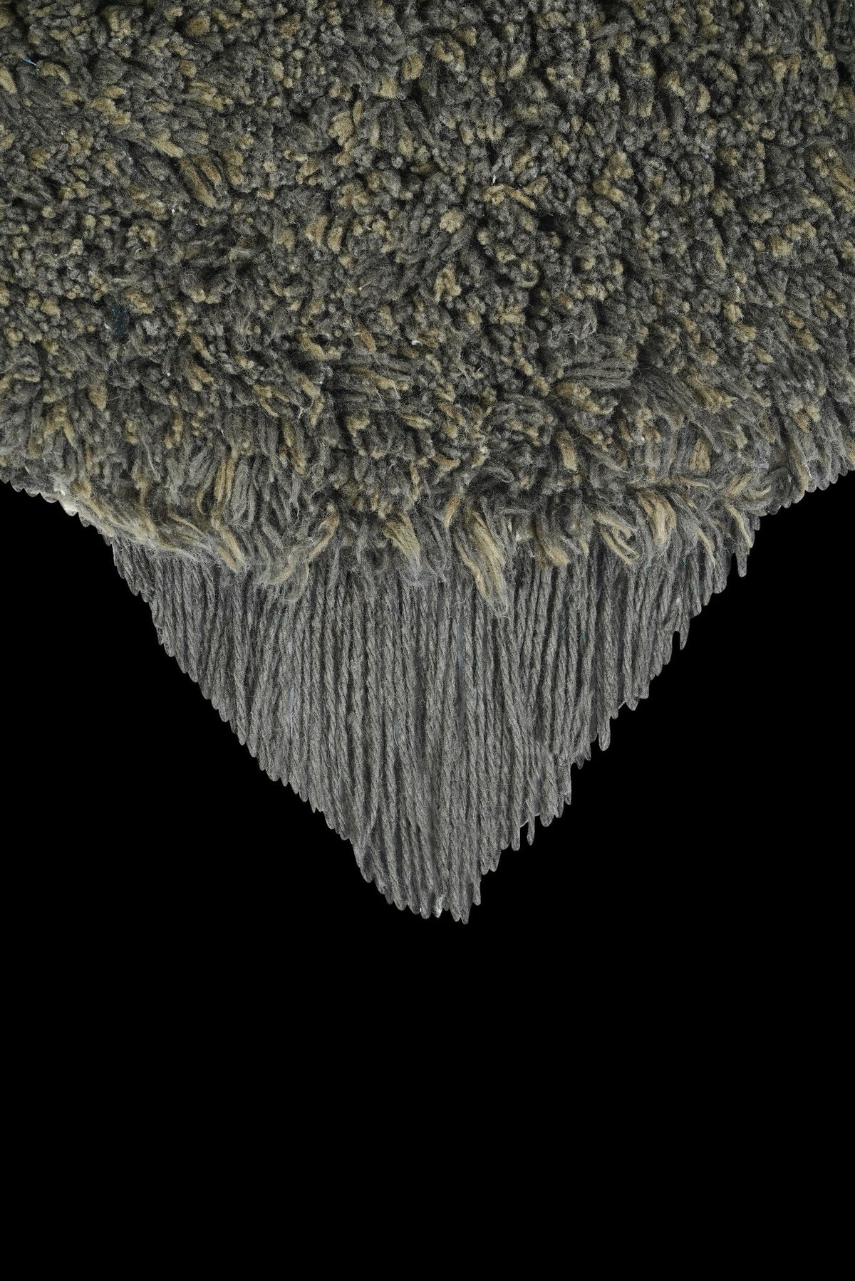 3. Detail of dark gray fluffy texture on bee rug with fringe edge